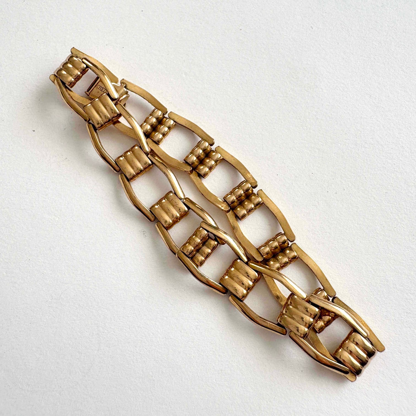 Kreisler gold tone bracelet on a white background