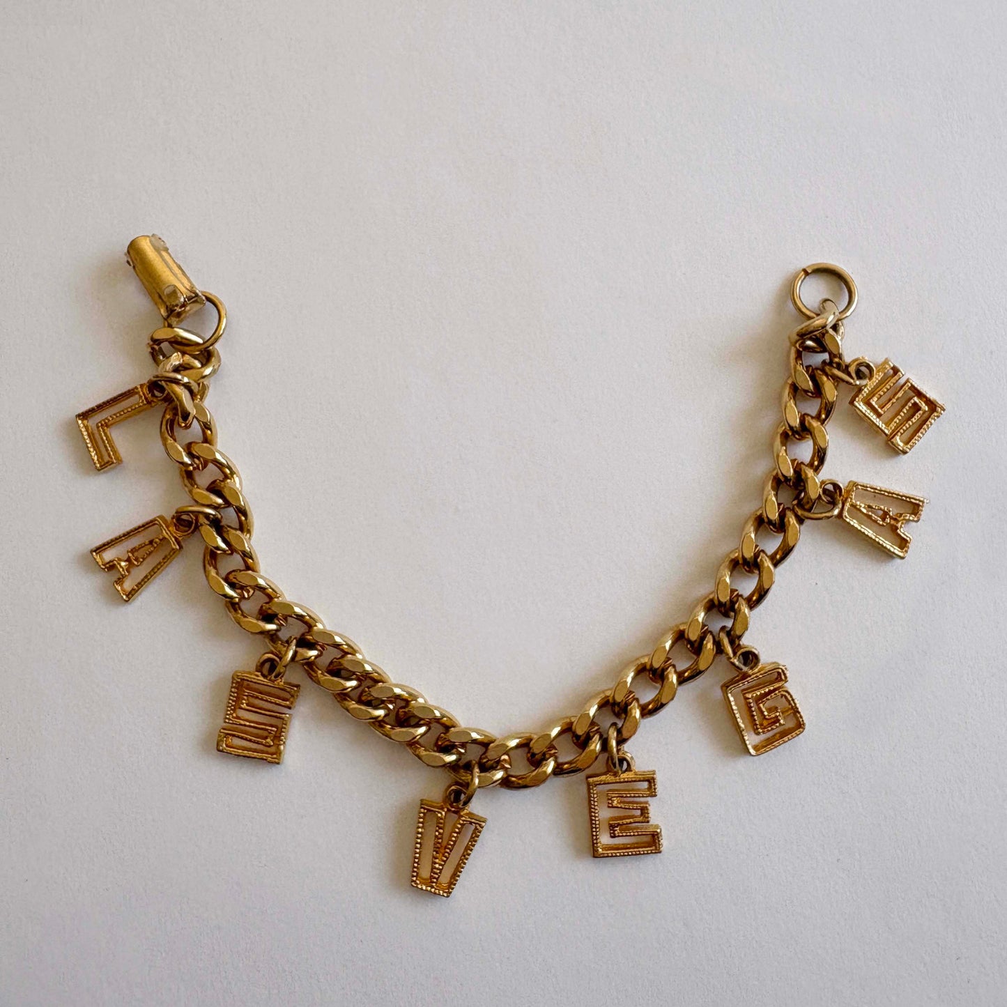 Vintage mid-century Las Vegas gold-tone charm bracelet with letter charms spelling LAS VEGAS
