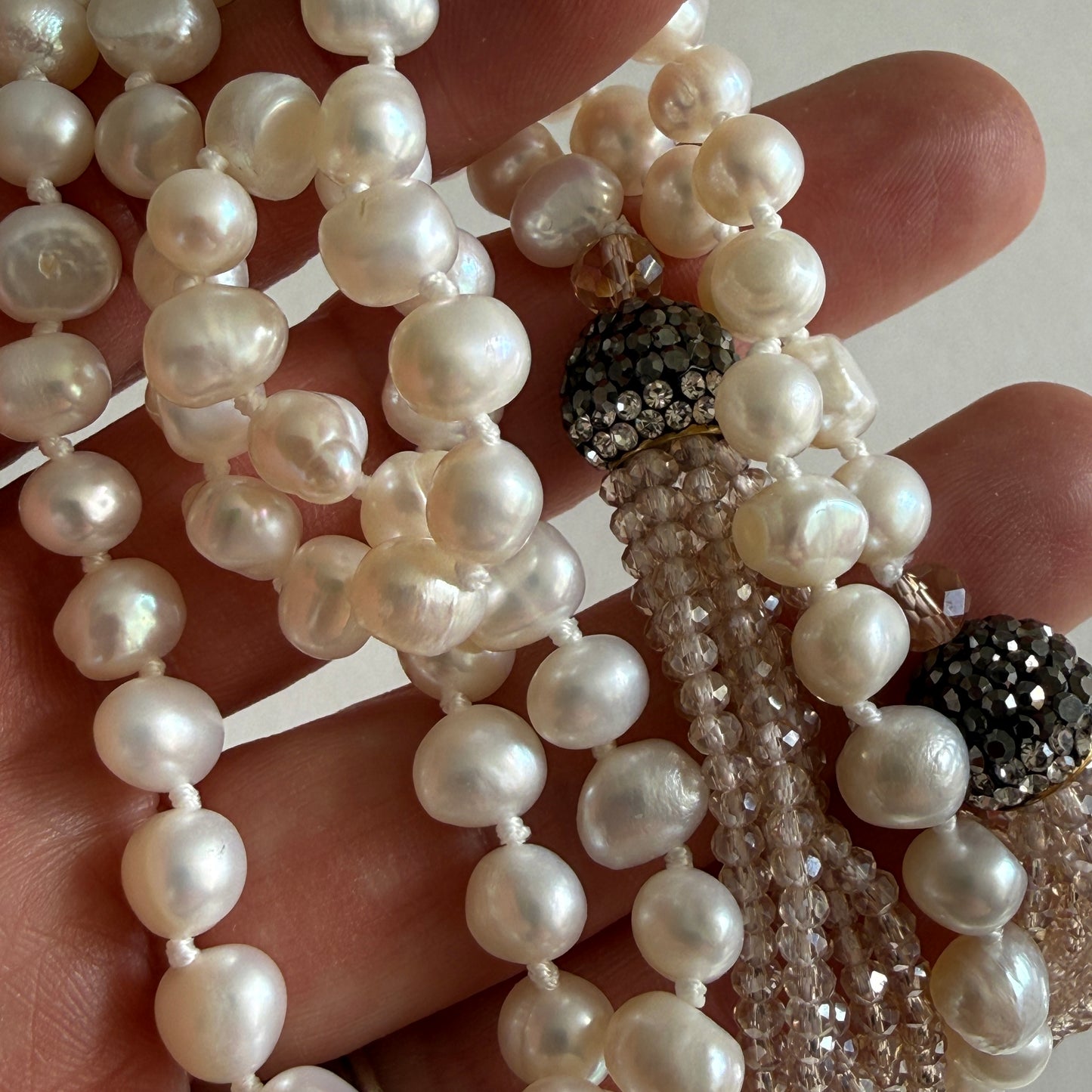 Handheld view of the Cascade lariat, demonstrating the fluid, serpentine drape and the impressive 38-inch total length.
