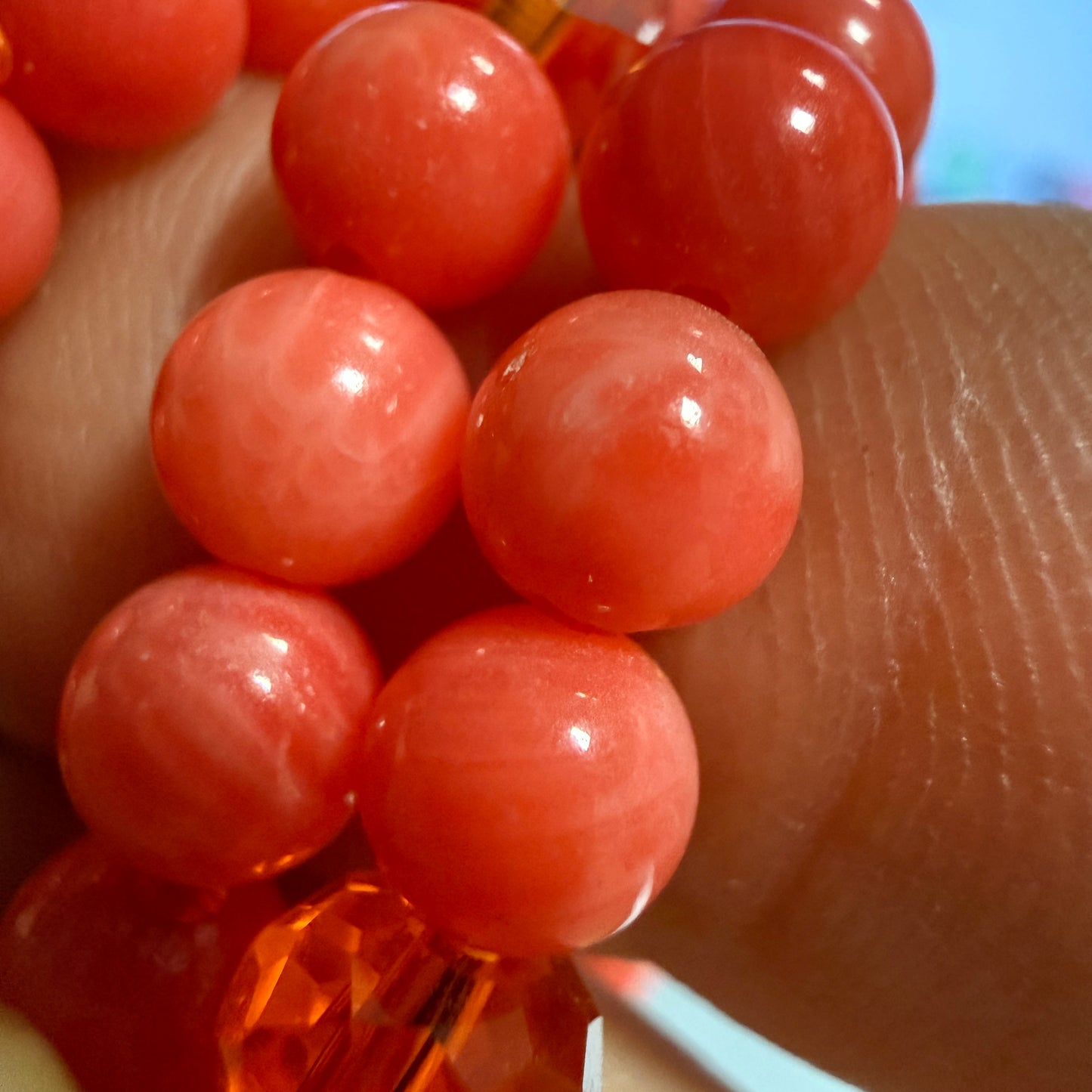 Macro close-up of dyed bamboo coral beads showing the natural black growth rings and organic porous texture characteristic of the species.