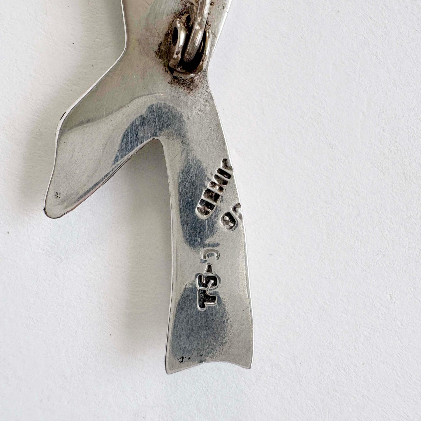 Silver brooch hallmark text on a white background