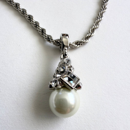 Pearl necklace with silver chain on a white background