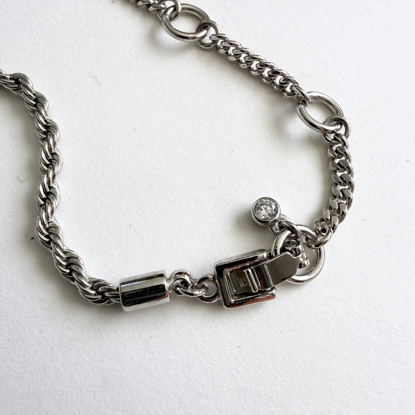 Silver chain necklace clasp on a white background