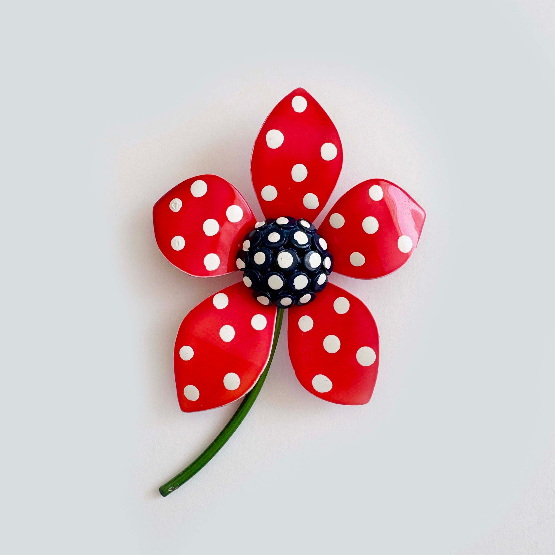 Vintage red enamel flower brooch with white polka dots and blue center, 1960s–1970s