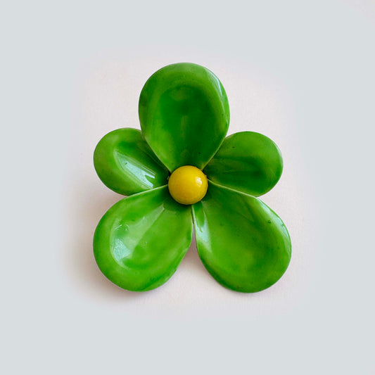 Vintage kelly green enamel flower brooch with yellow center, five petal mod daisy design from the 1960s–1970s
