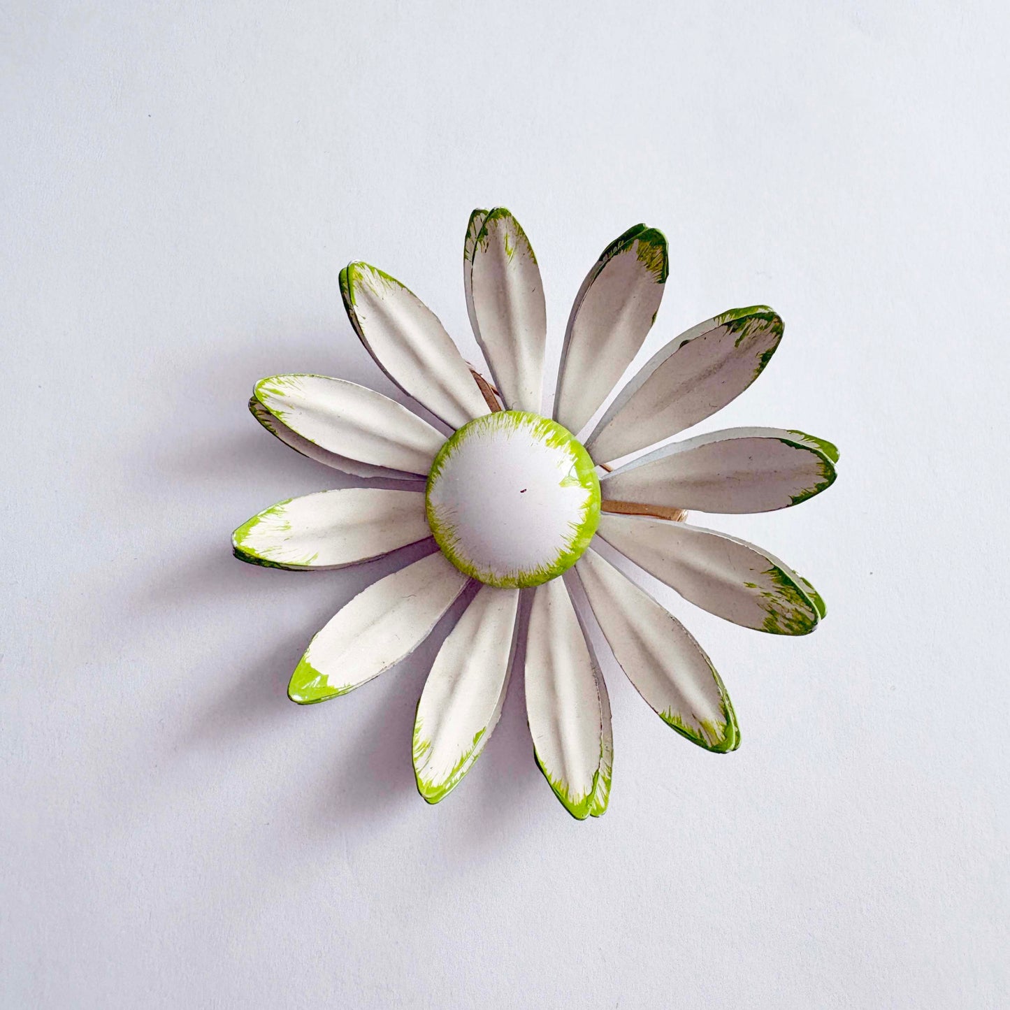 Vintage white enamel daisy brooch with green tipped petals, 1960s