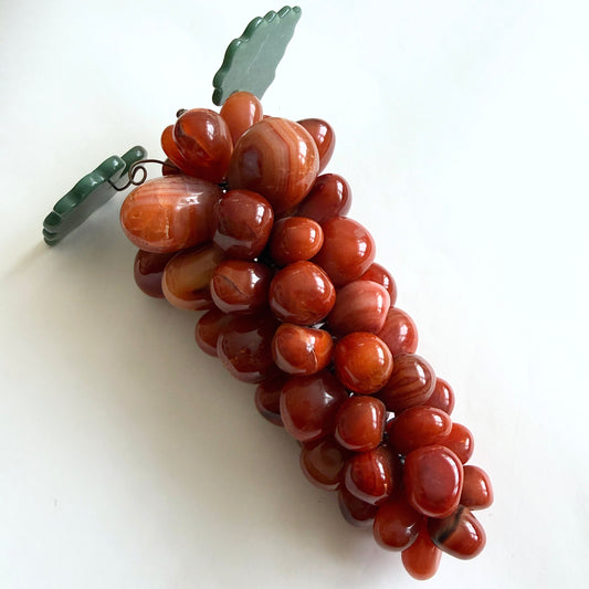 Decorative stone grapes on a white background