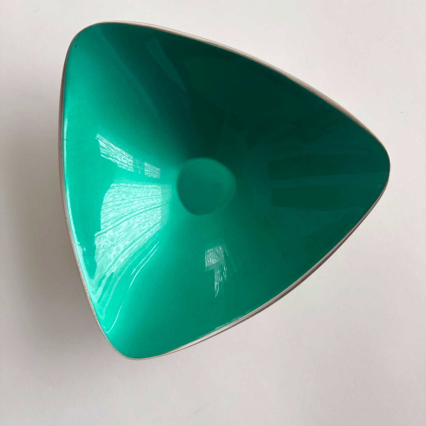 Triangular green bowl on a white background