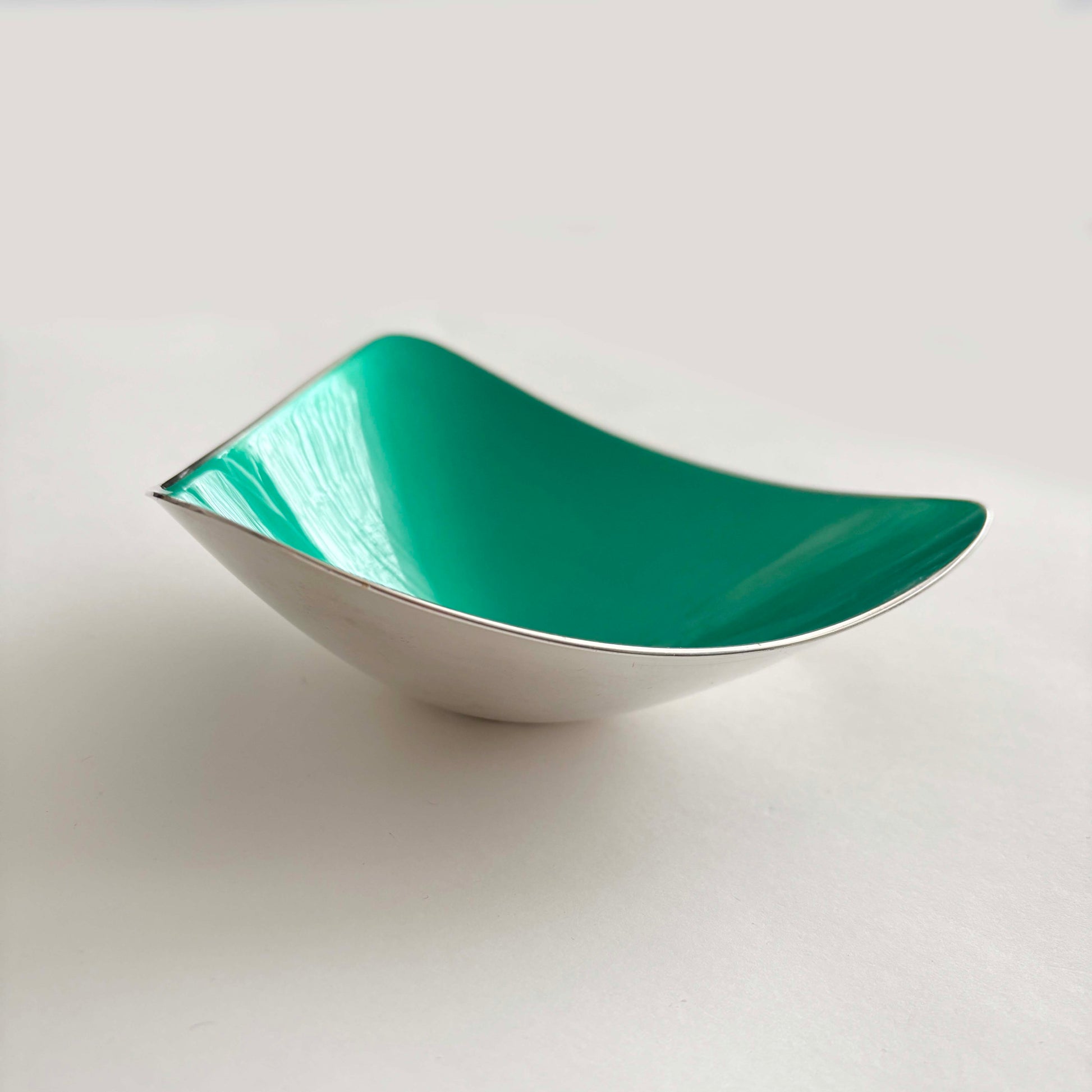 Teal silver bowl on a white background