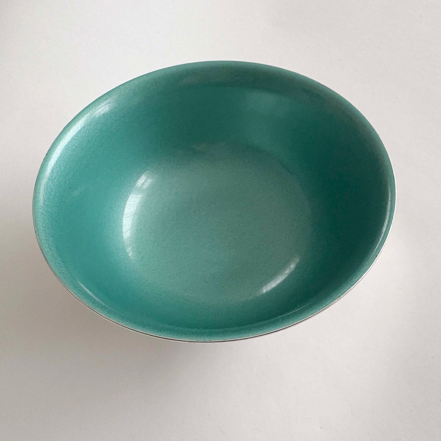 Green silver bowl on a white background