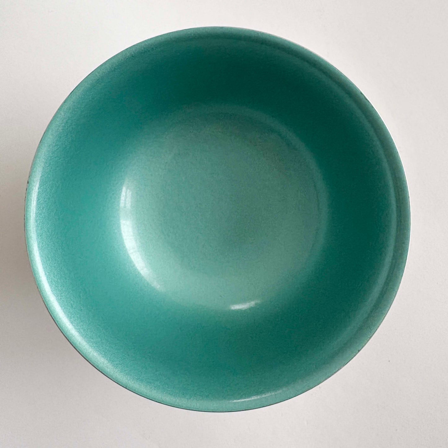 Green silver bowl on a white background