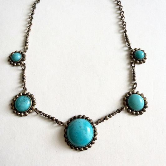 Vintage Czech turquoise glass cabochon necklace with five molded glass stones set in aged silver tone metal with brass patina.