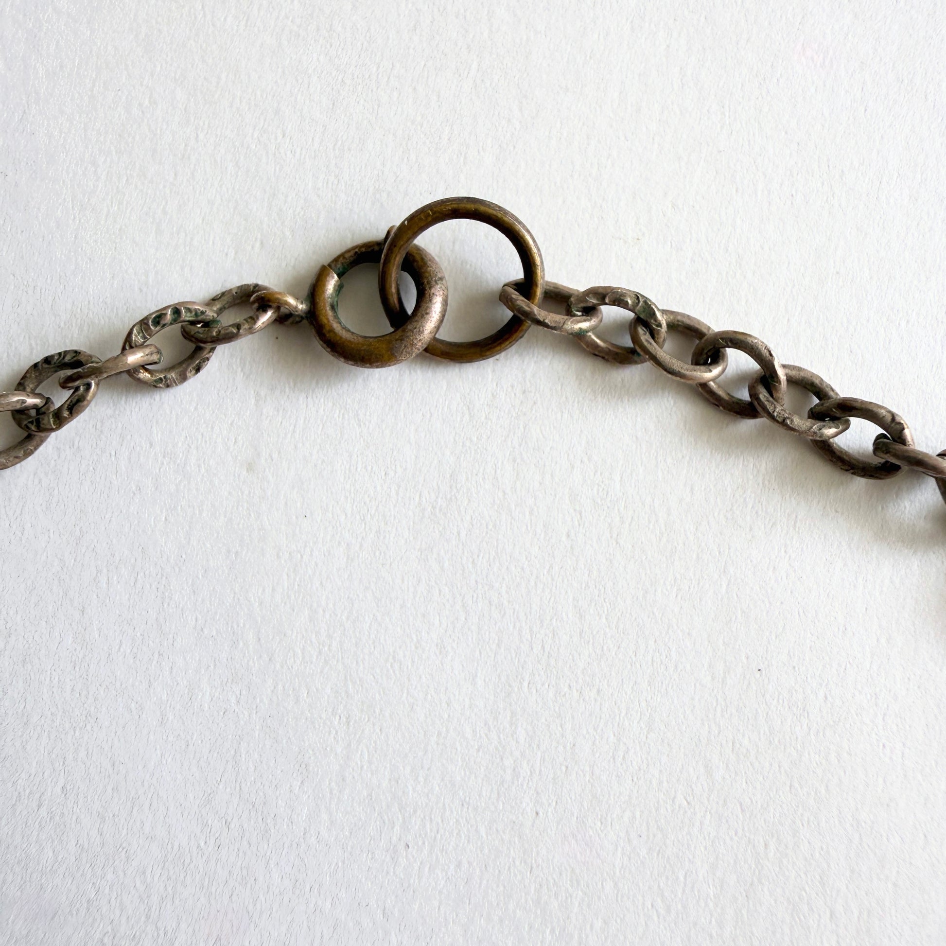 Close-up of a chain necklace on a white background