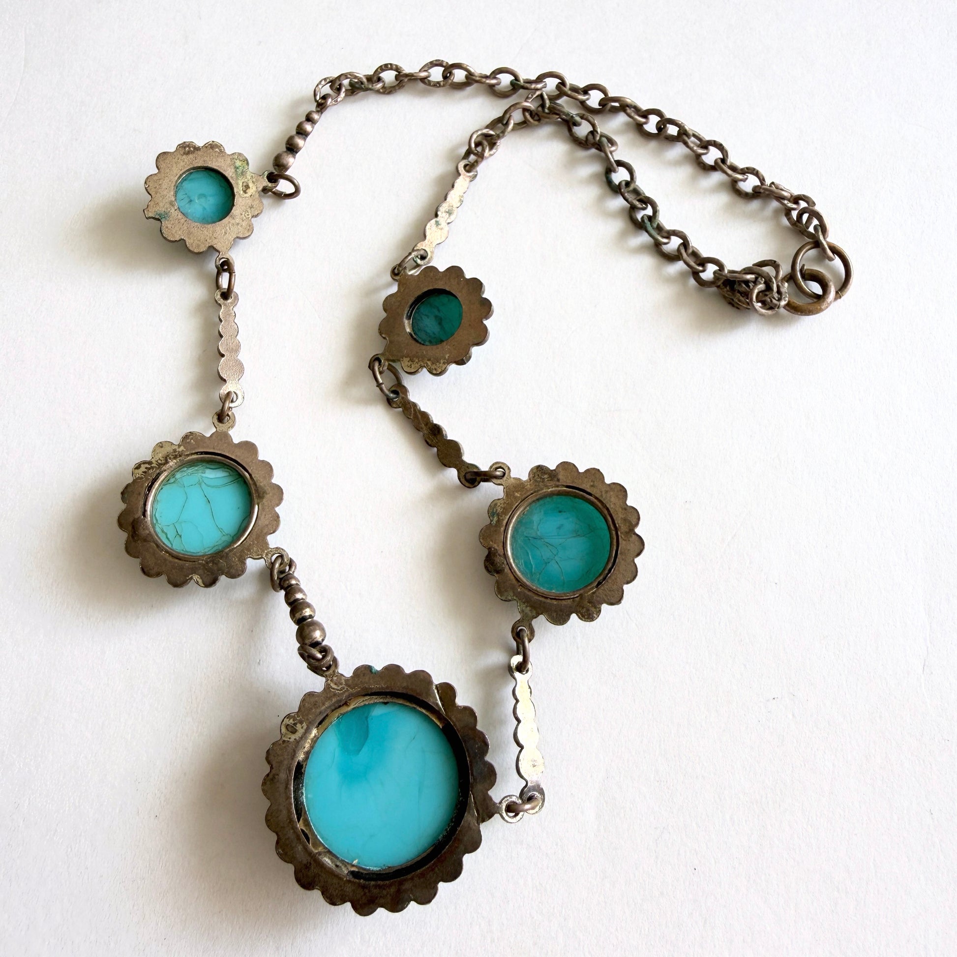Vintage Czech turquoise glass cabochon necklace with five molded glass stones set in aged silver tone metal with brass patina; back of necklace
