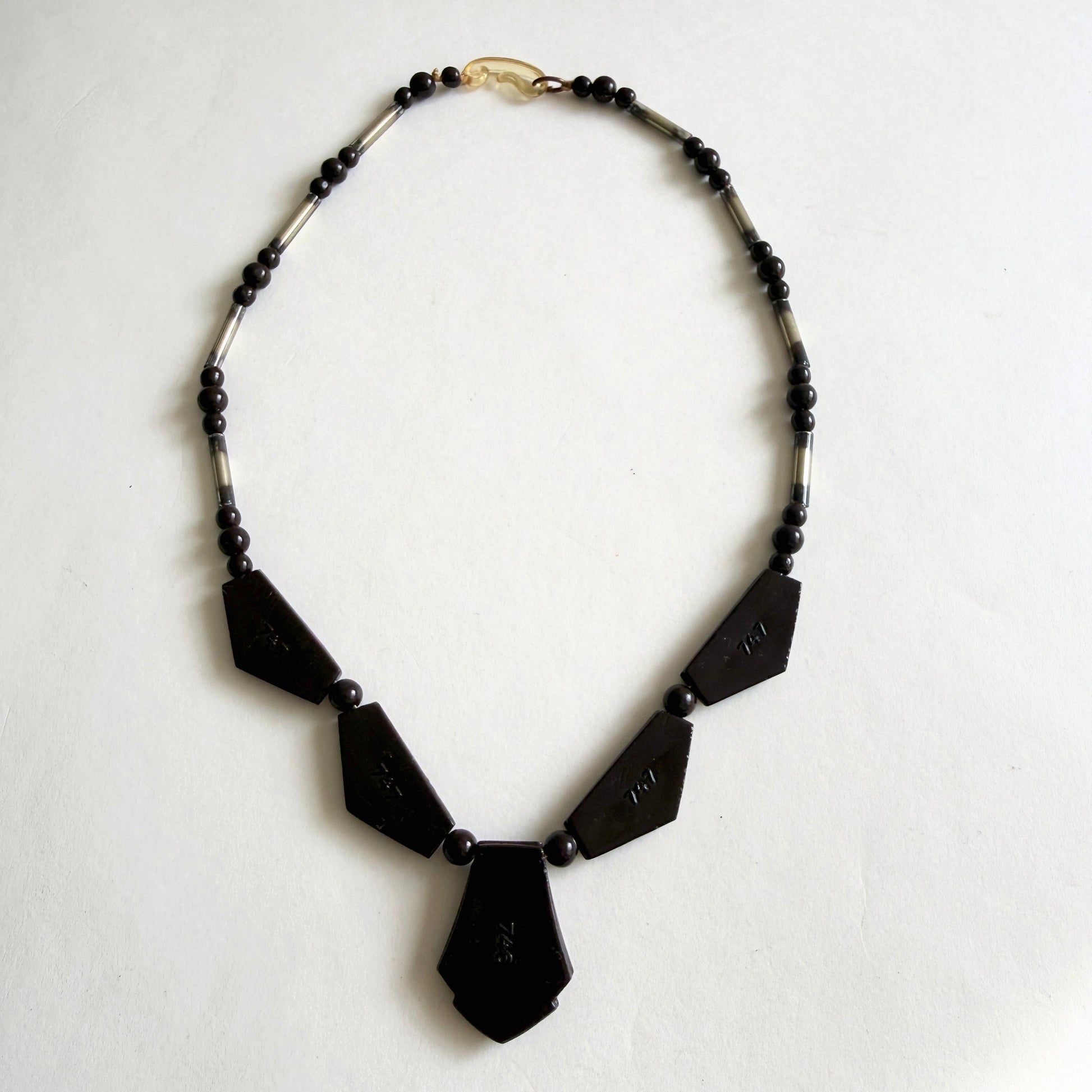 Vintage Czech Art Deco necklace with dark amethyst molded glass panels, rhinestone accents and silvered glass tube beads, circa 1930s.
