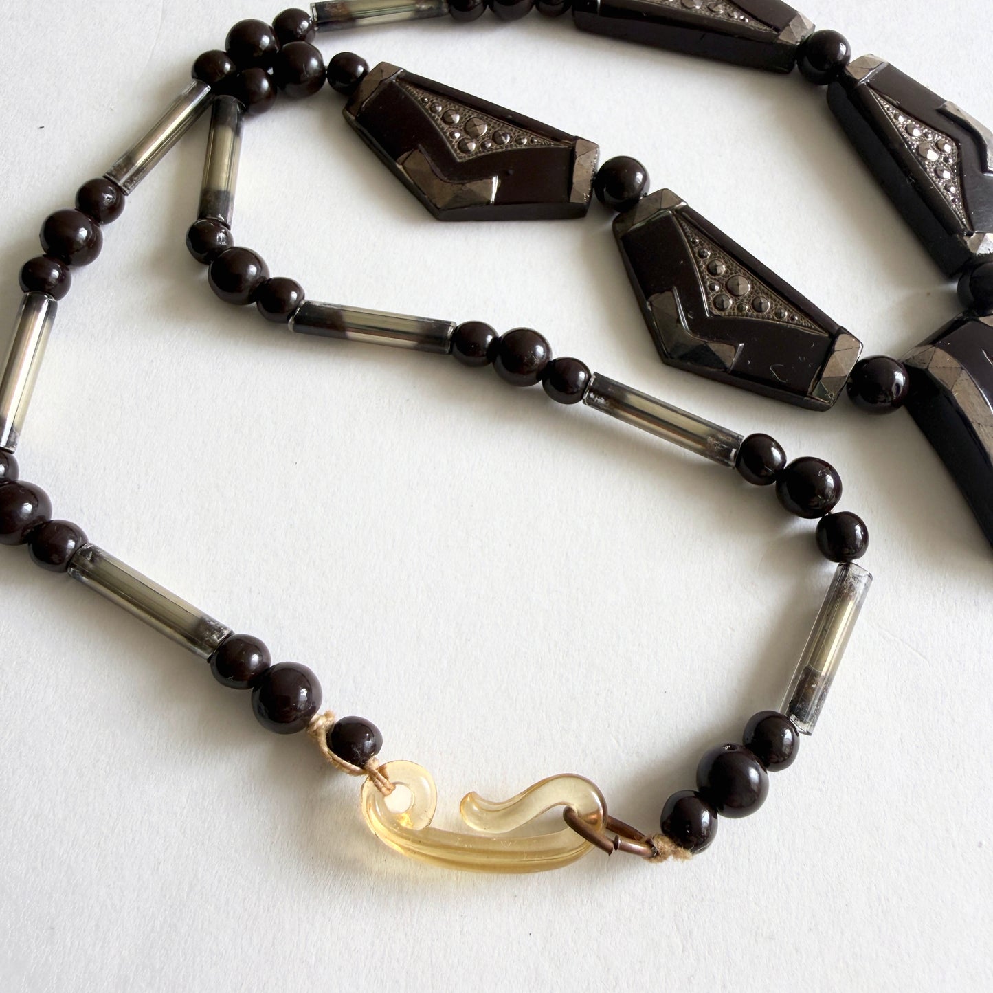 Vintage Czech Art Deco necklace with dark amethyst molded glass panels, rhinestone accents and silvered glass tube beads, circa 1930s.