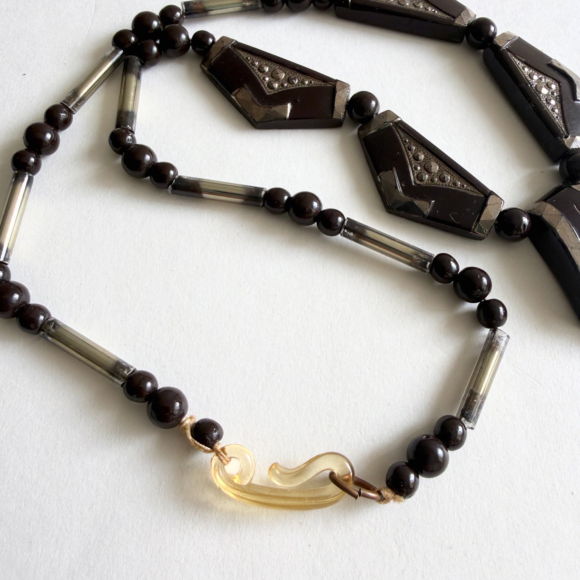 Vintage Czech Art Deco necklace with dark amethyst molded glass panels, rhinestone accents and silvered glass tube beads, circa 1930s.