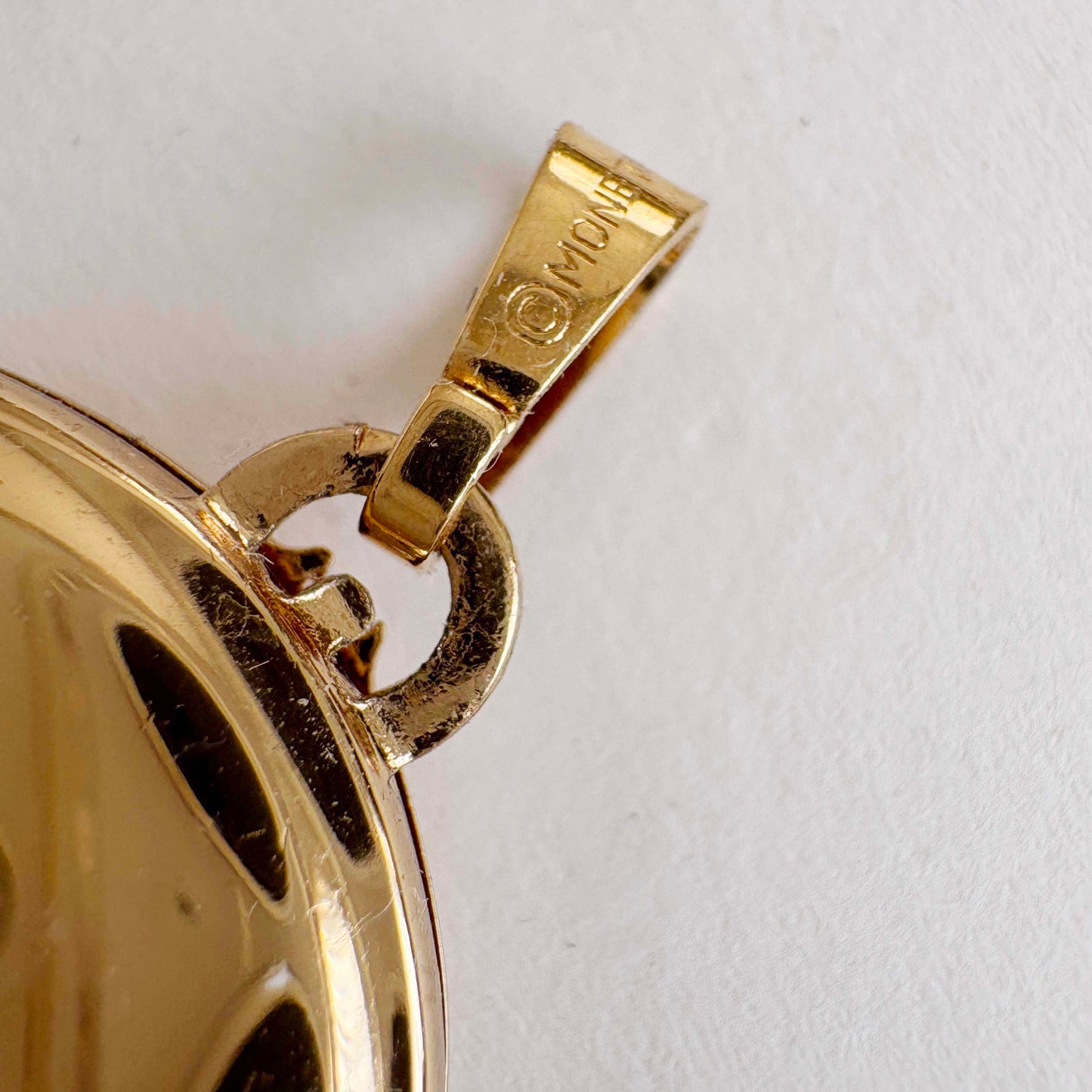 Vintage Monet gold-tone 1980s costume jewelry on white background