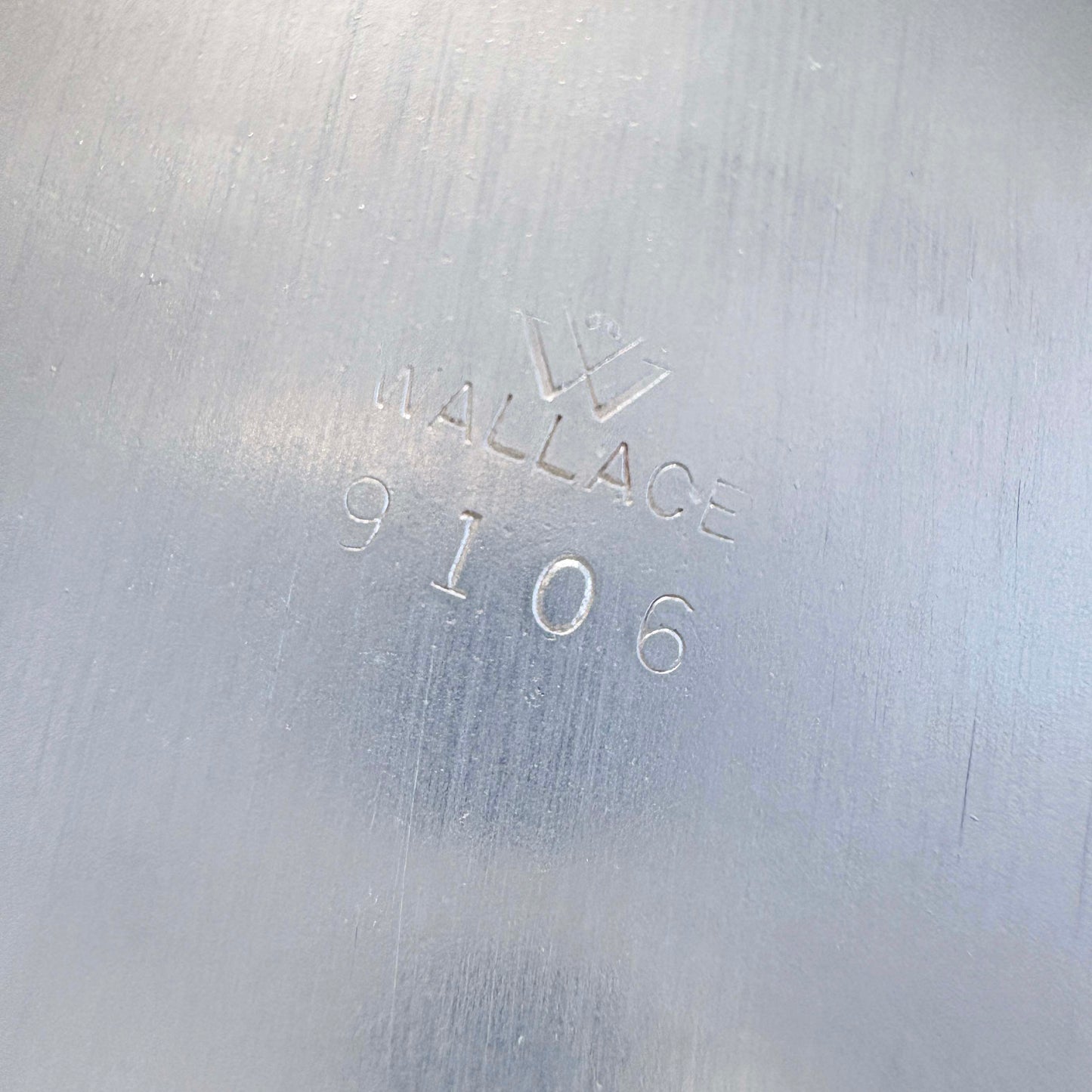 Metal surface with 'Wallace 9106' engraving
