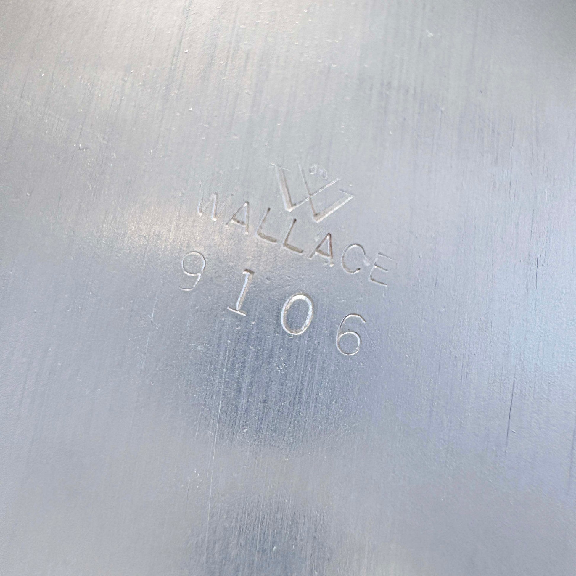 Metal surface with 'Wallace 9106' engraving