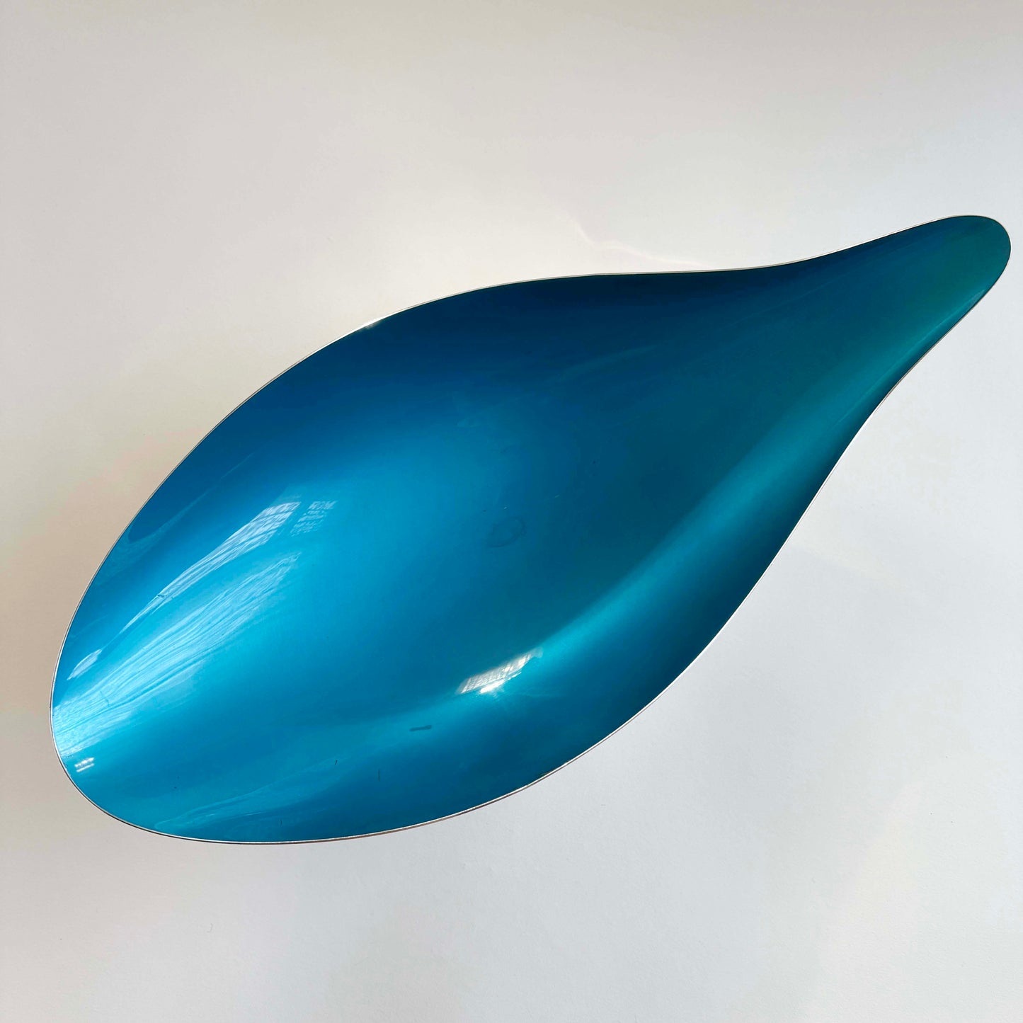 Blue, teardrop-shaped bowl on a white background