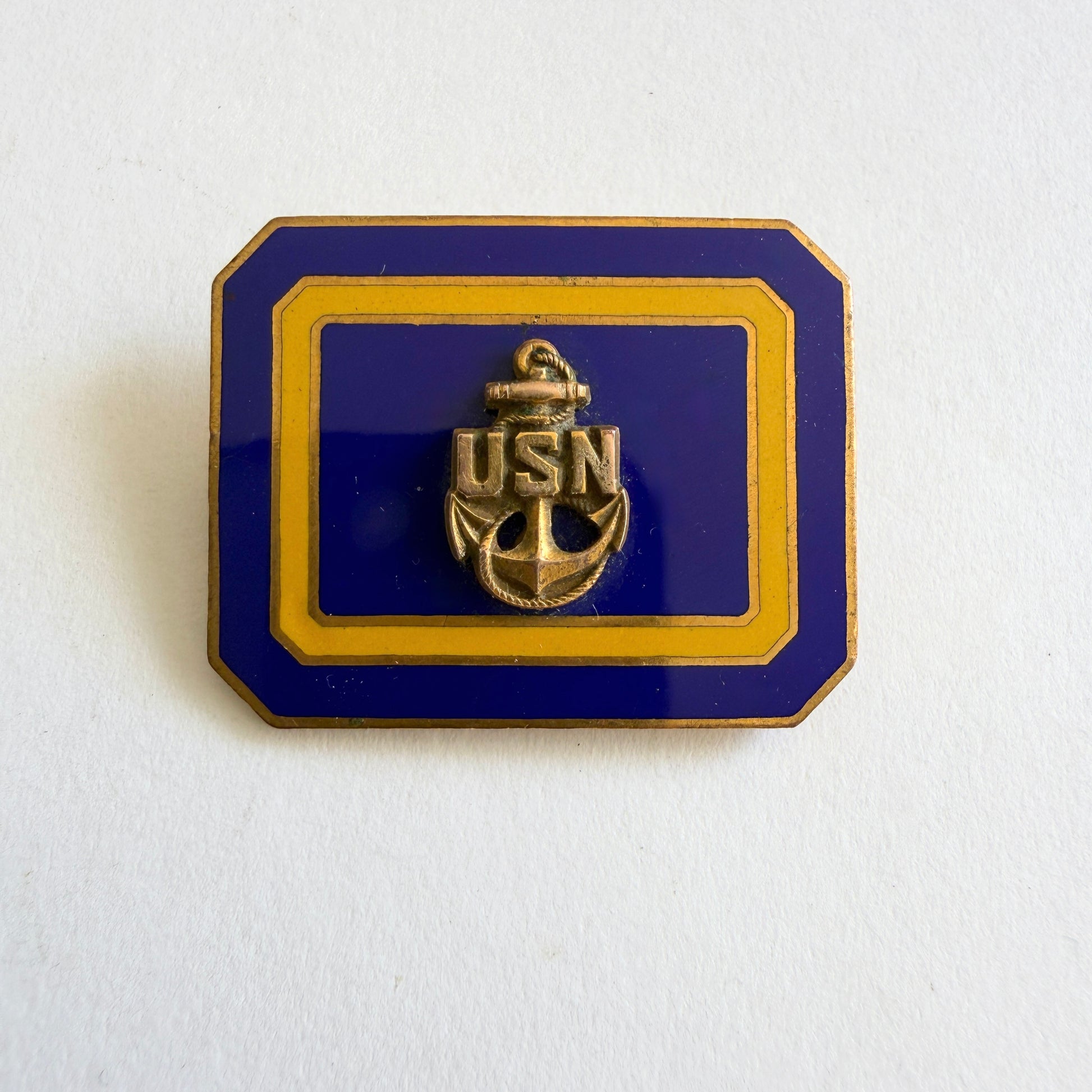 Vintage USN anchor brooch with navy blue enamel and gold tone frame, mid-century circa 1950s–60s