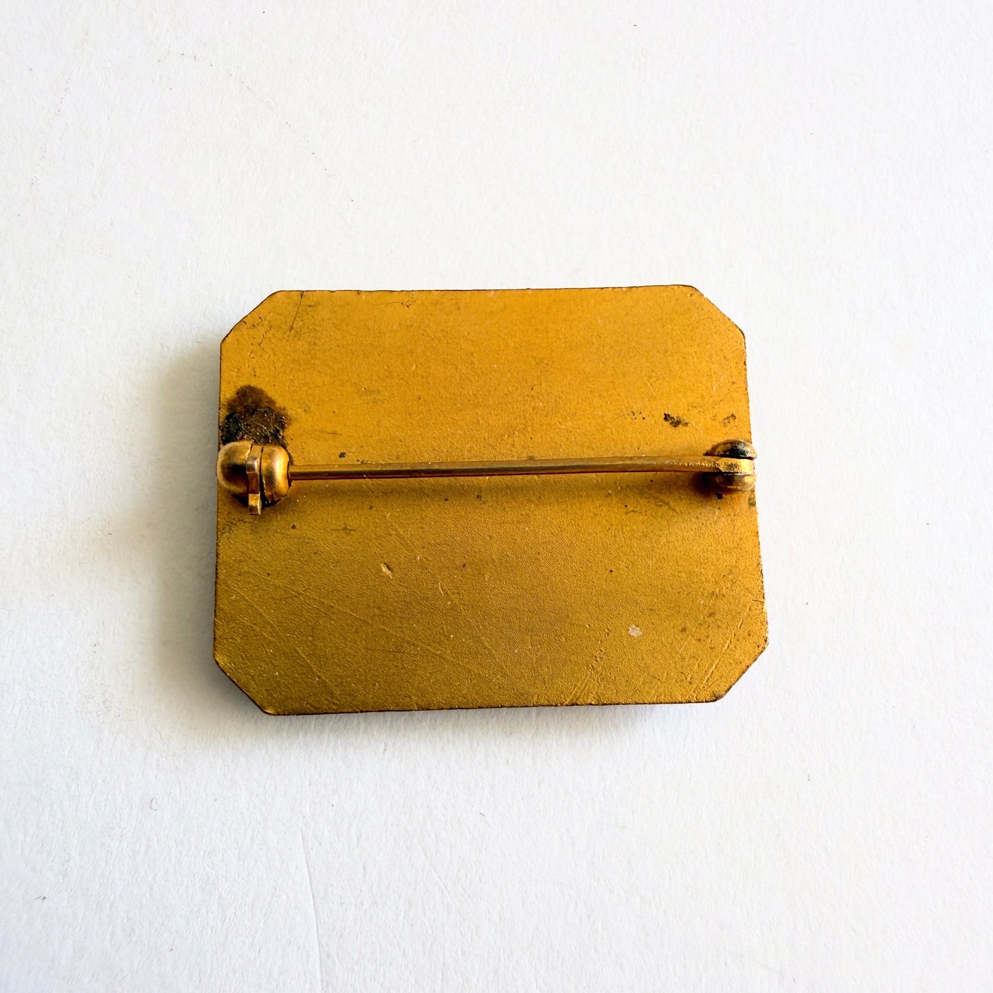 Gold brooch on a white background