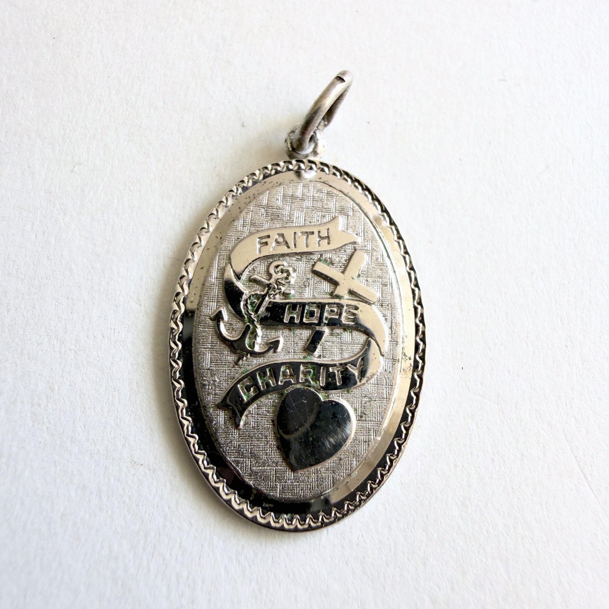 Vintage sterling silver pendant with faith hope charity symbols including cross anchor and heart