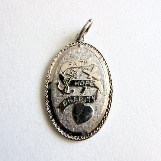 Vintage sterling silver pendant with faith hope charity symbols including cross anchor and heart