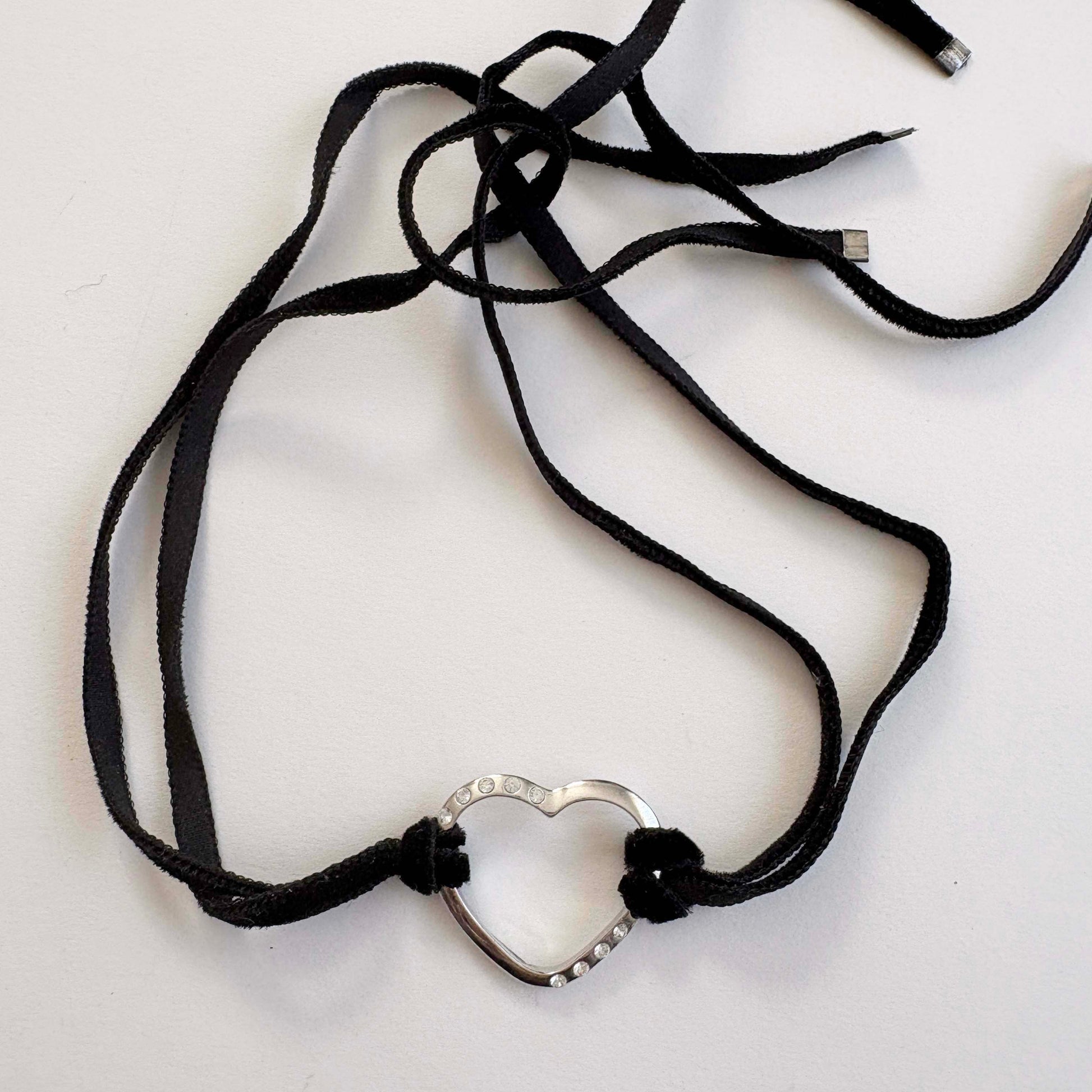 Furla sterling silver open heart choker necklace with black velvet tie cords on white background