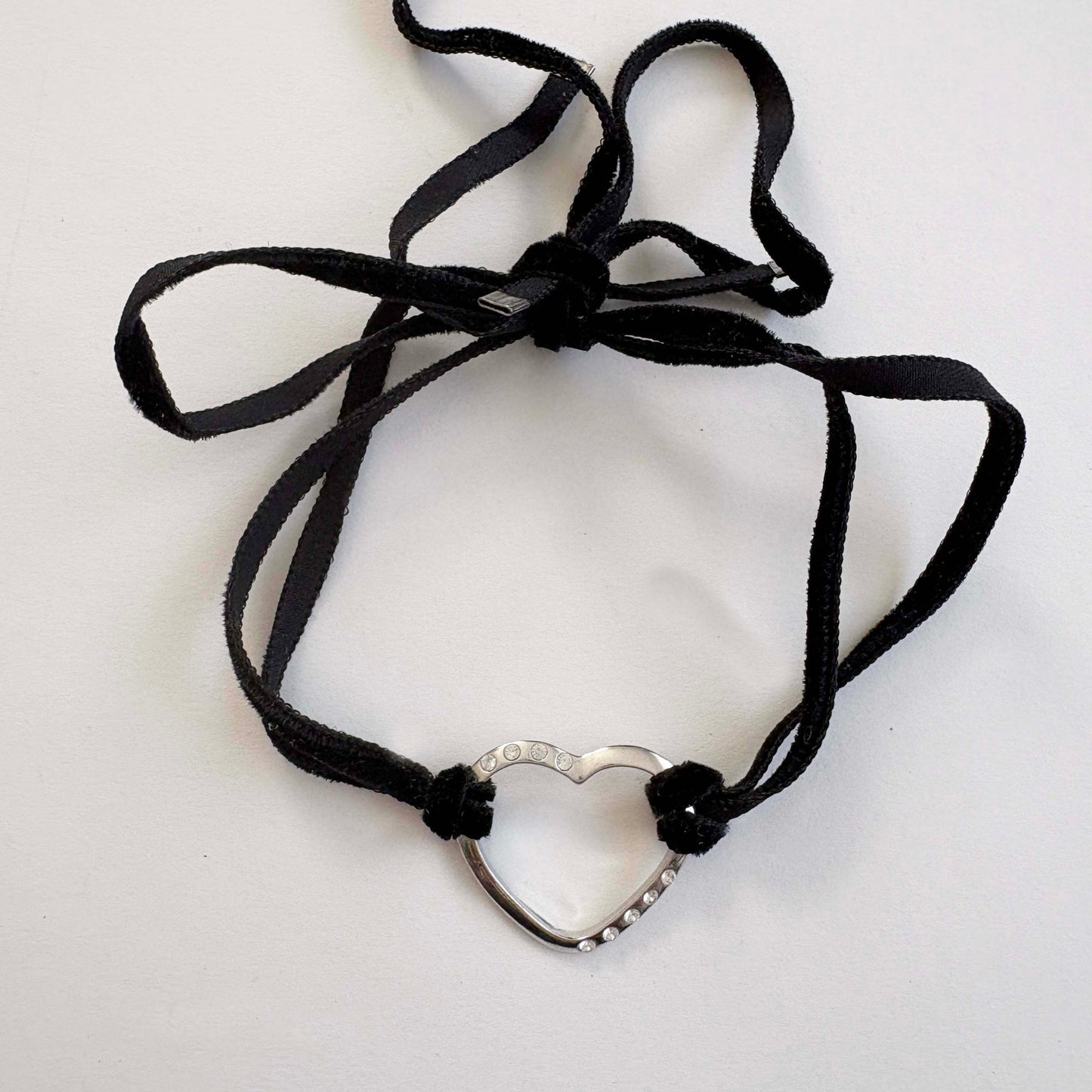 Furla sterling silver open heart choker necklace with black velvet tie cords on white background
