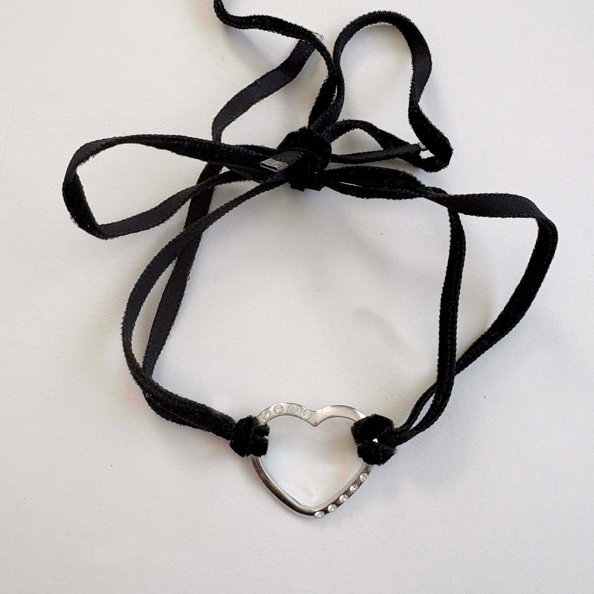 Furla sterling silver open heart choker necklace with black velvet tie cords on white background