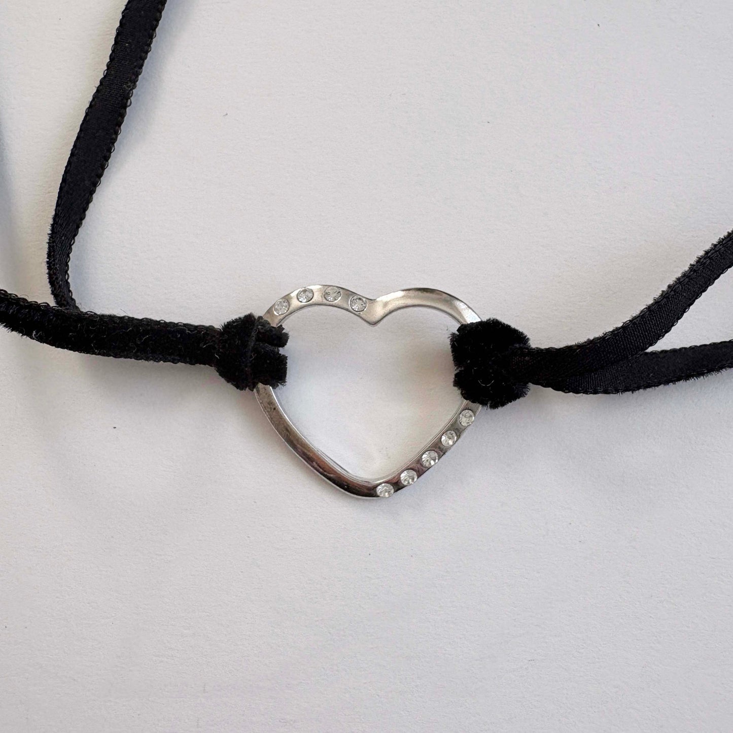 Furla sterling silver open heart choker necklace with black velvet tie cords on white background