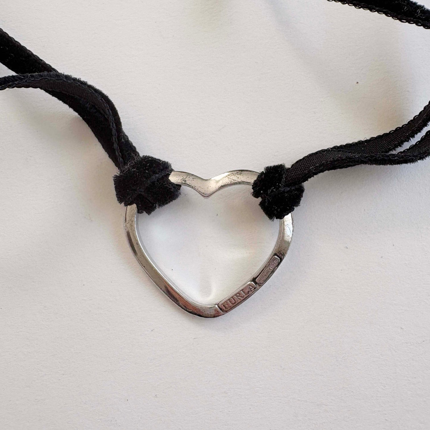 Furla sterling silver open heart choker necklace with black velvet tie cords on white background