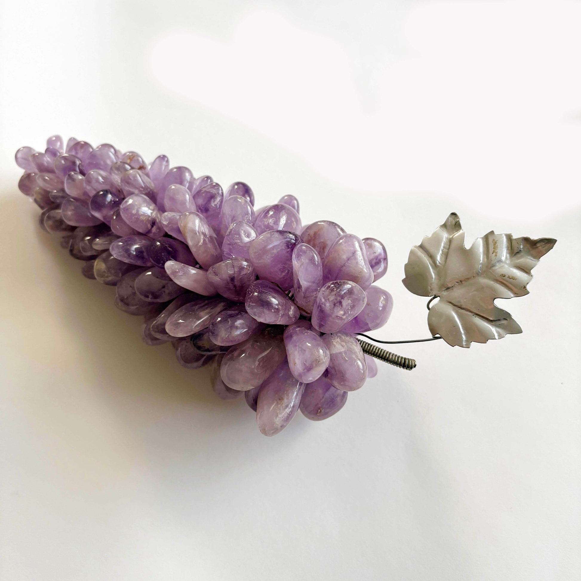 Purple stone gra[es with silver leaf design on a white background