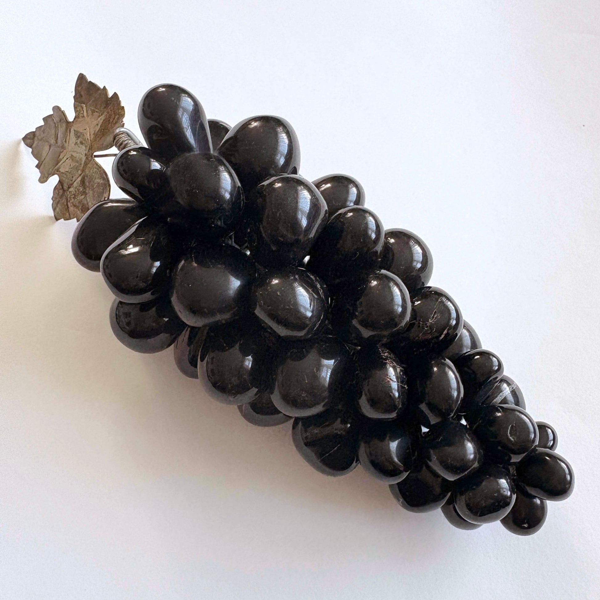Black grapes on a white background
