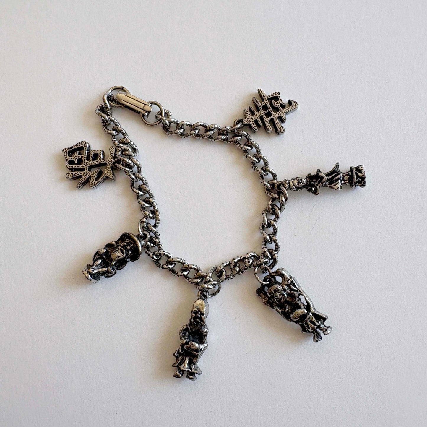 Vintage silver-tone Asian tourist charm bracelet with figural charms attributed to Coro