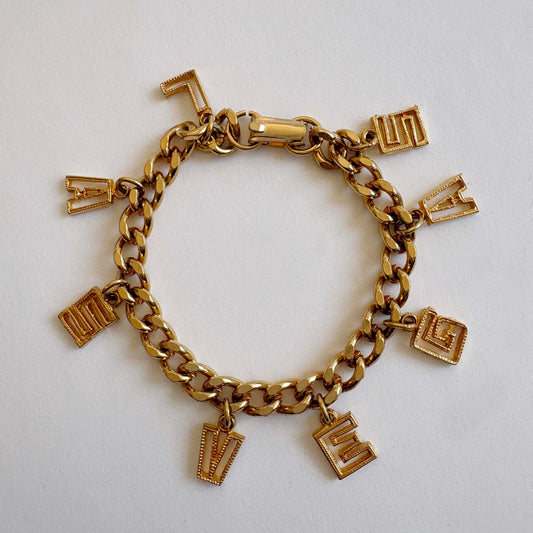 Vintage mid-century Las Vegas gold-tone charm bracelet with letter charms spelling LAS VEGAS