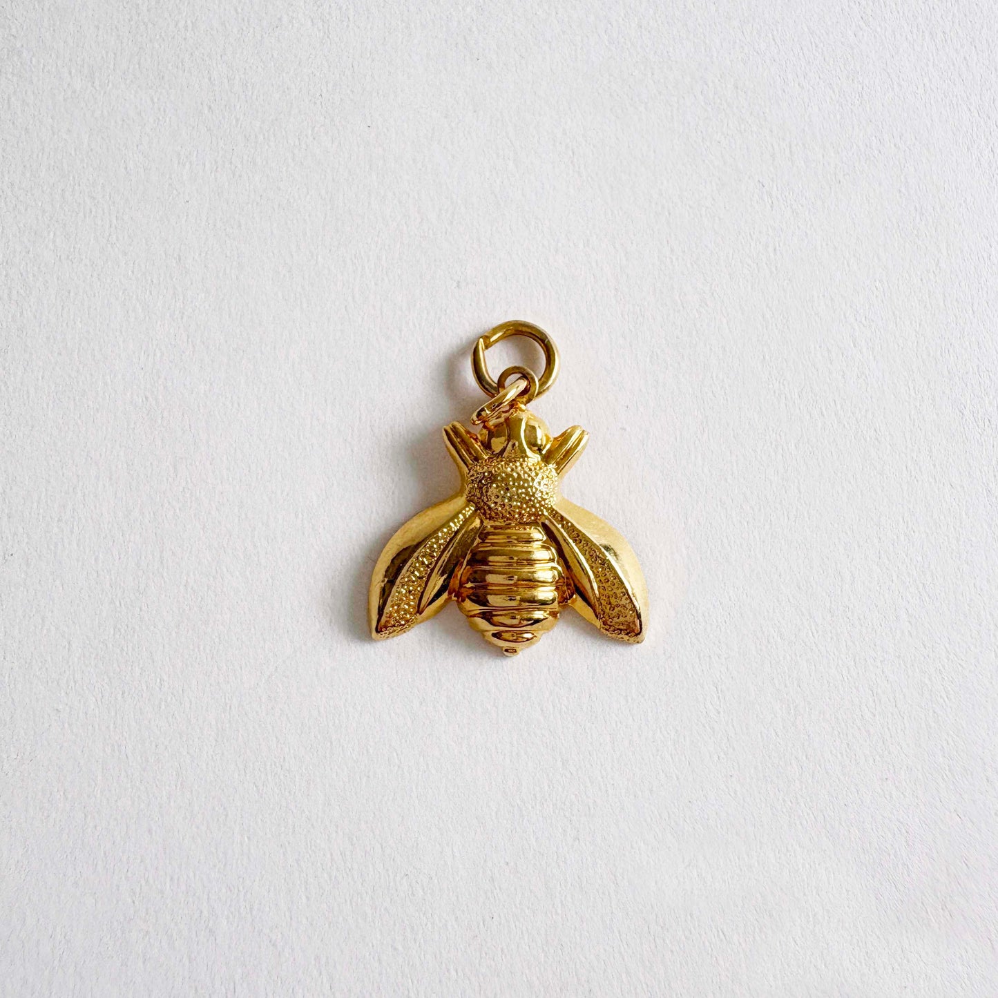 Vintage gold-tone bumble bee charm pendant with textured wings and polished body, 1980s jewelry