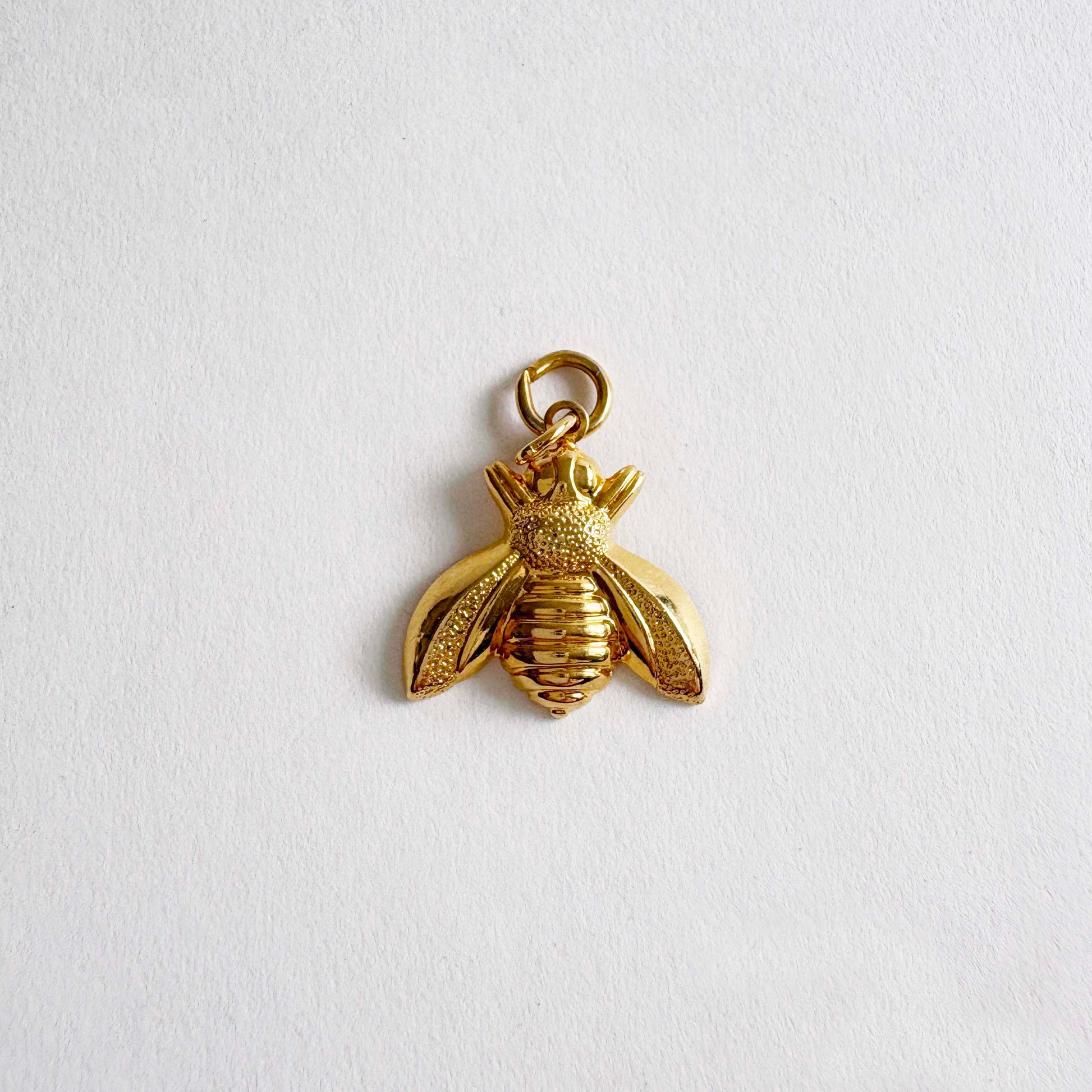 Vintage gold-tone bumble bee charm pendant with textured wings and polished body, 1980s jewelry
