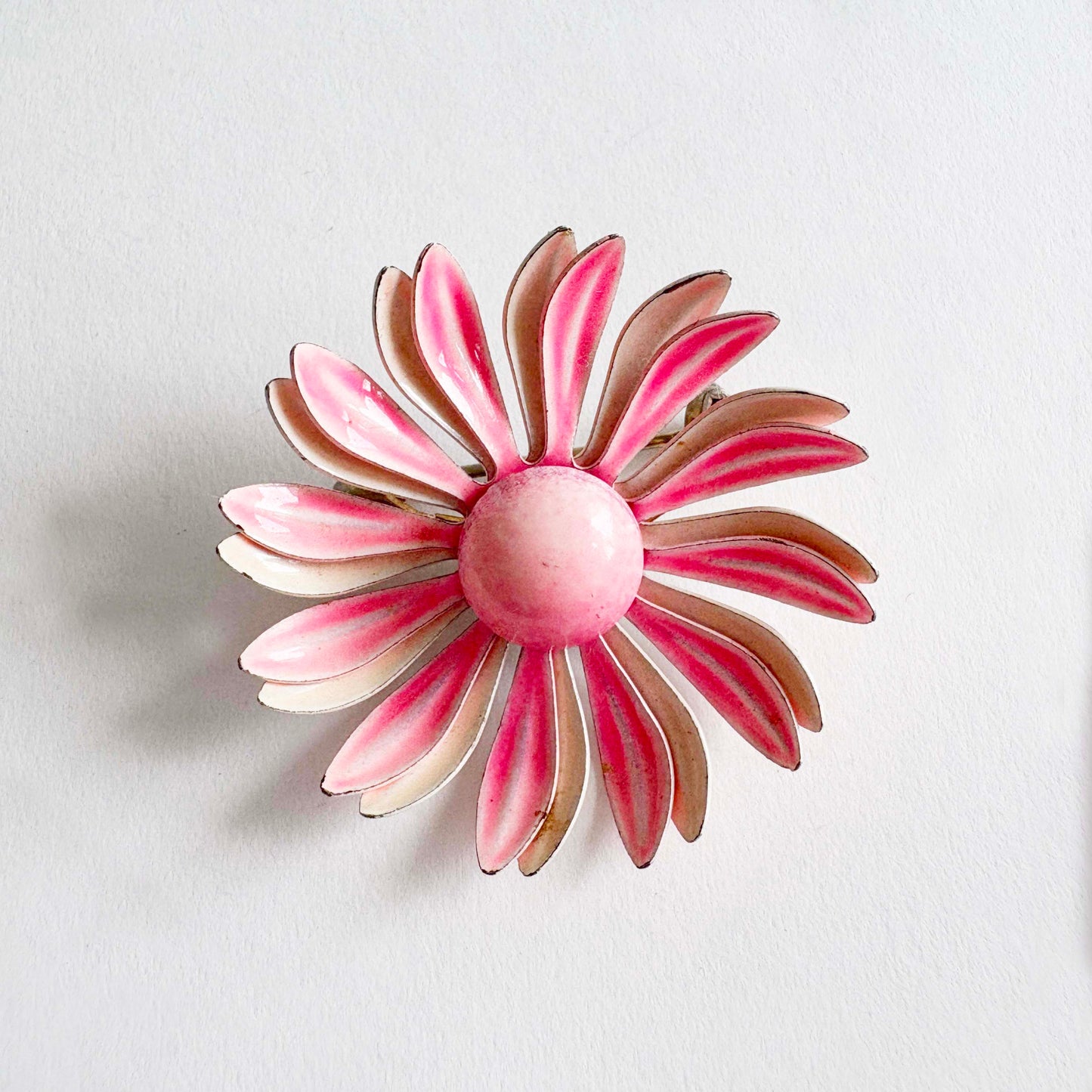 Vintage two-tone pink enamel flower brooch with saturated pink center over pale pink background, 1960s–70s mod pop-art pin.