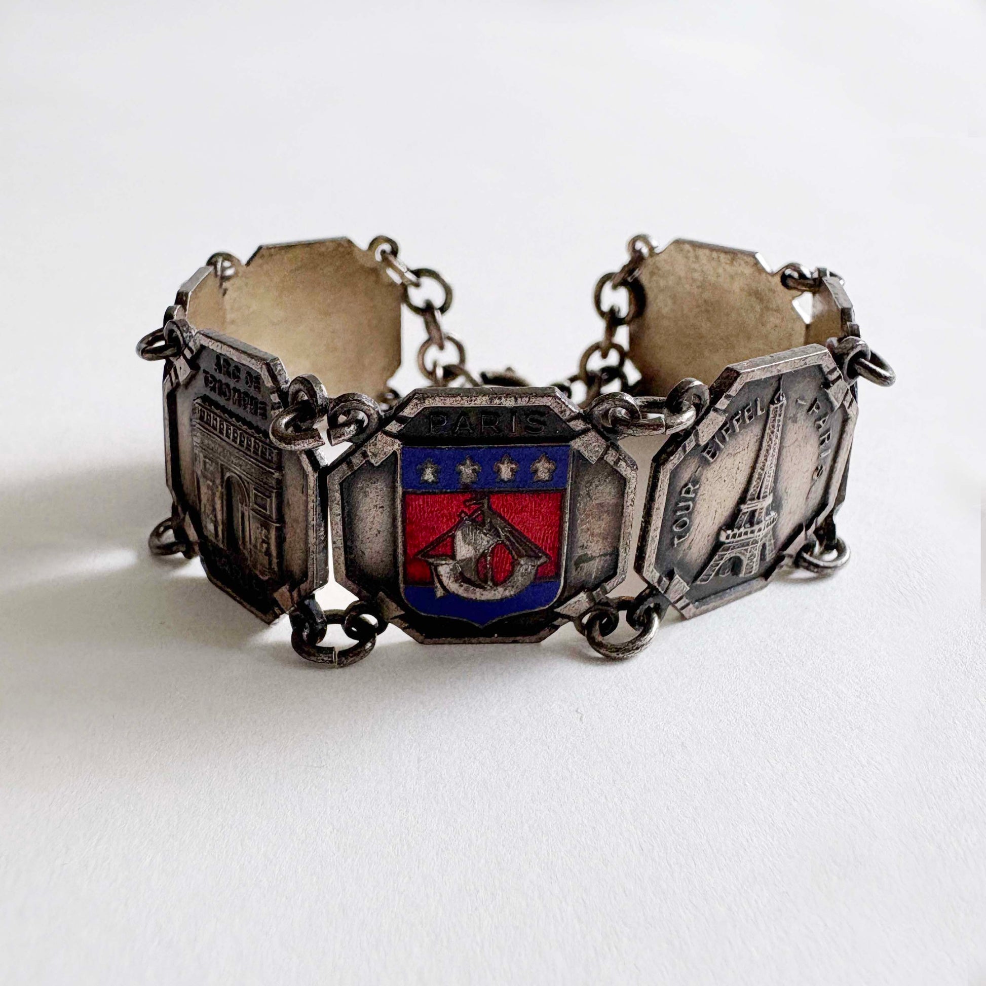 Vintage Paris souvenir silver-tone panel bracelet with enamel Paris coat of arms and landmark panels on white background