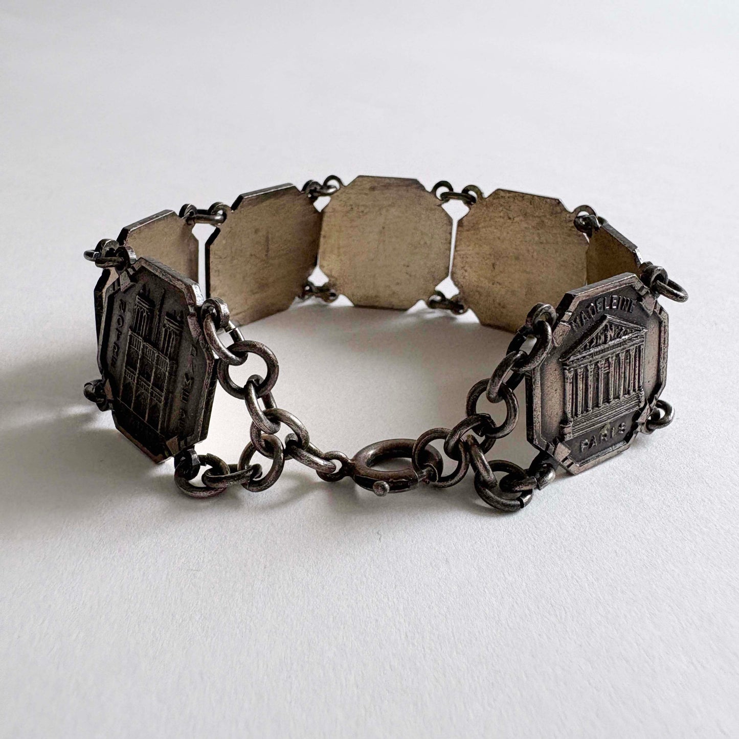 Vintage Paris souvenir silver-tone panel bracelet with landmark panels on white background