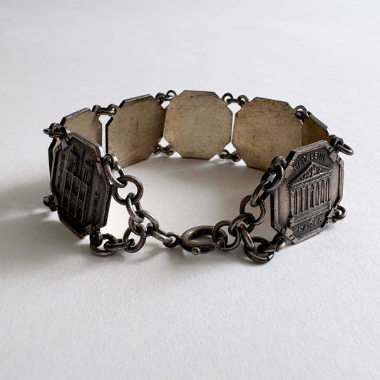 Vintage Paris souvenir silver-tone panel bracelet with landmark panels on white background