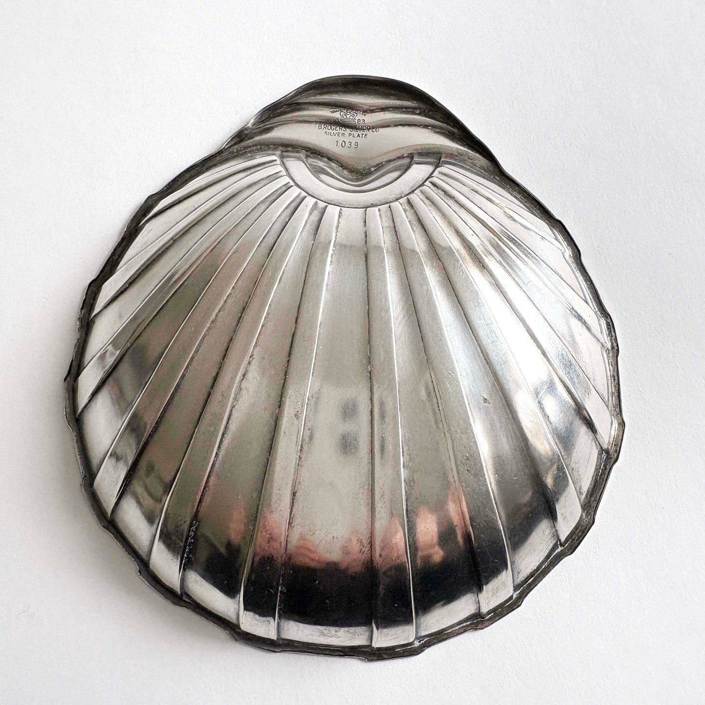 Art Deco shell-shaped silver plate dish by F.B. Rogers on white background