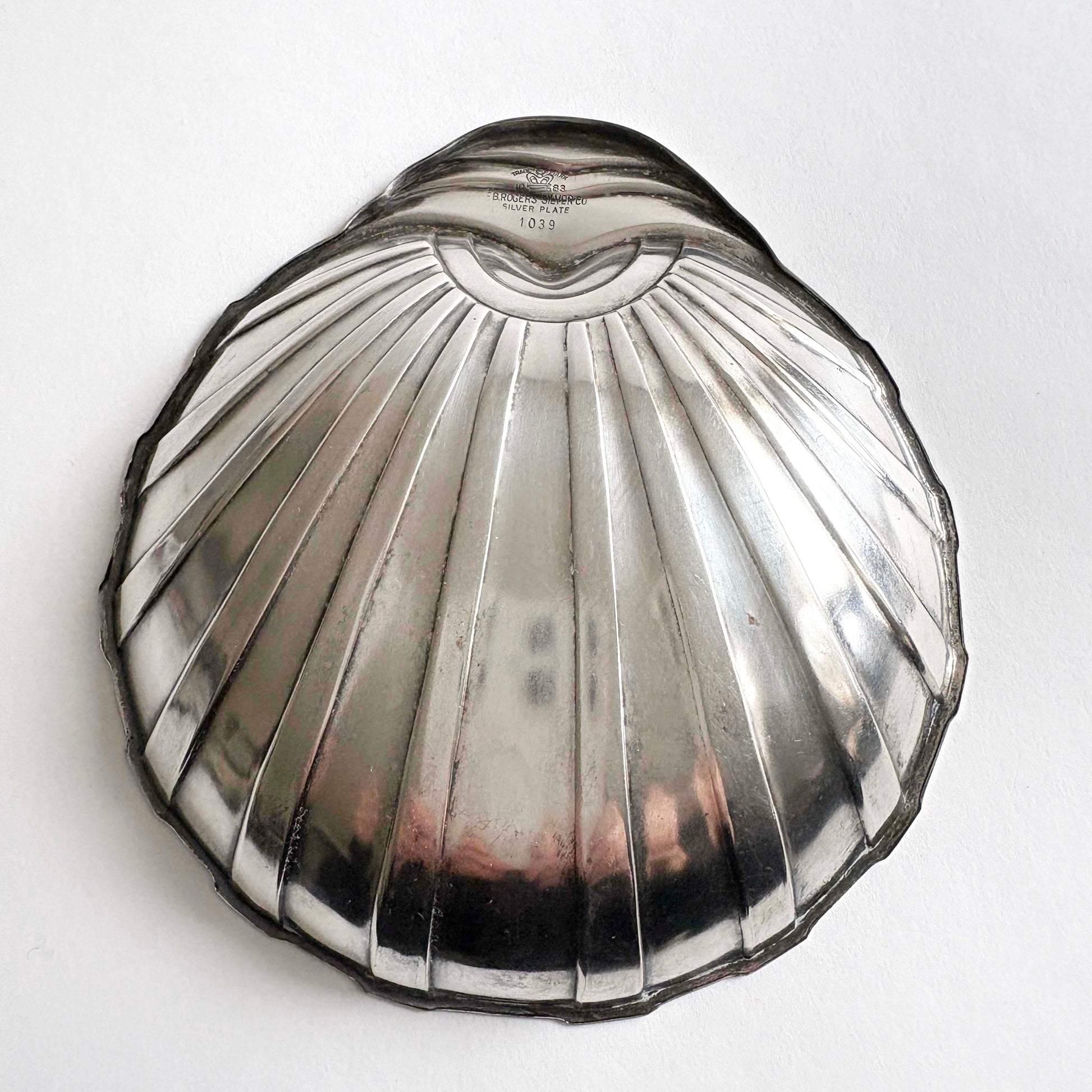 Art Deco shell-shaped silver plate dish by F.B. Rogers on white background
