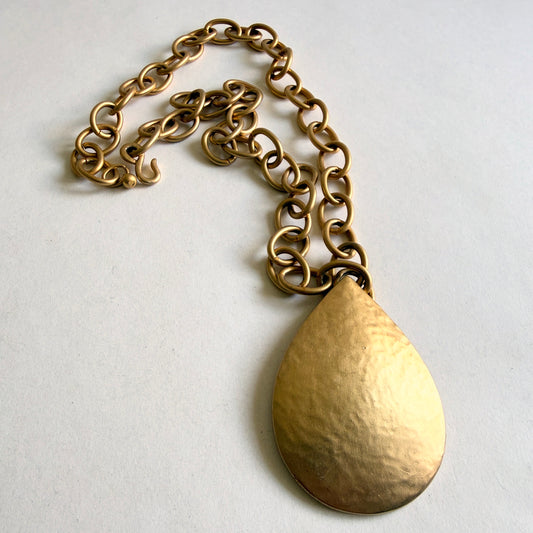 Kenneth Jay Lane vintage matte gold teardrop necklace on white gallery background - The Hallmark Edit