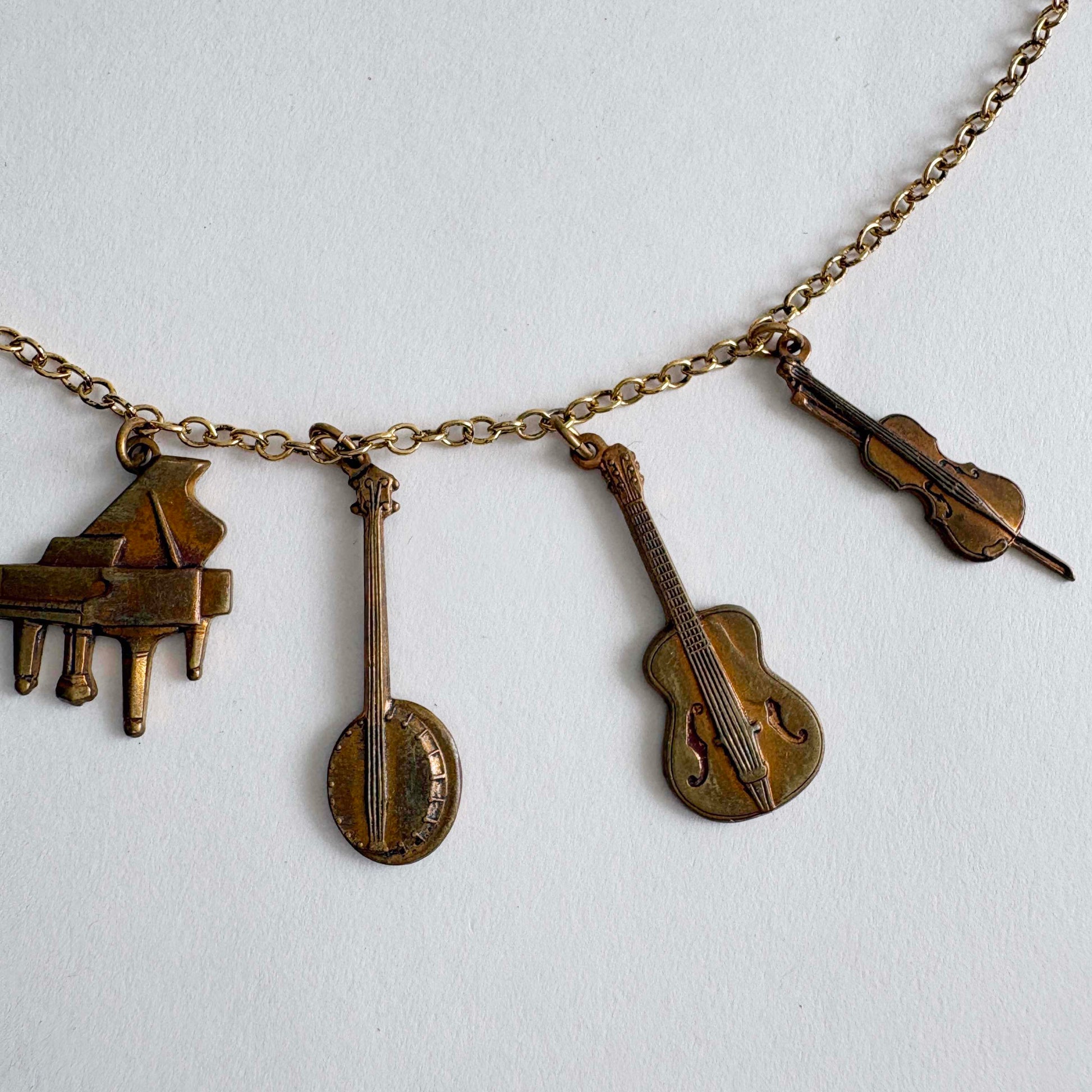 Necklace with musical instrument charms on a white background