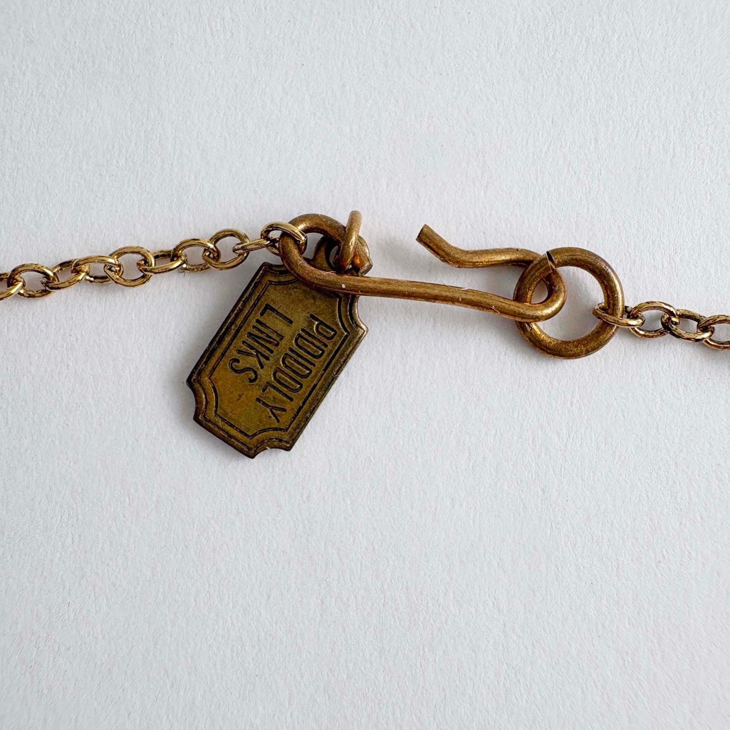 Brass bracelet with a tag on a white background