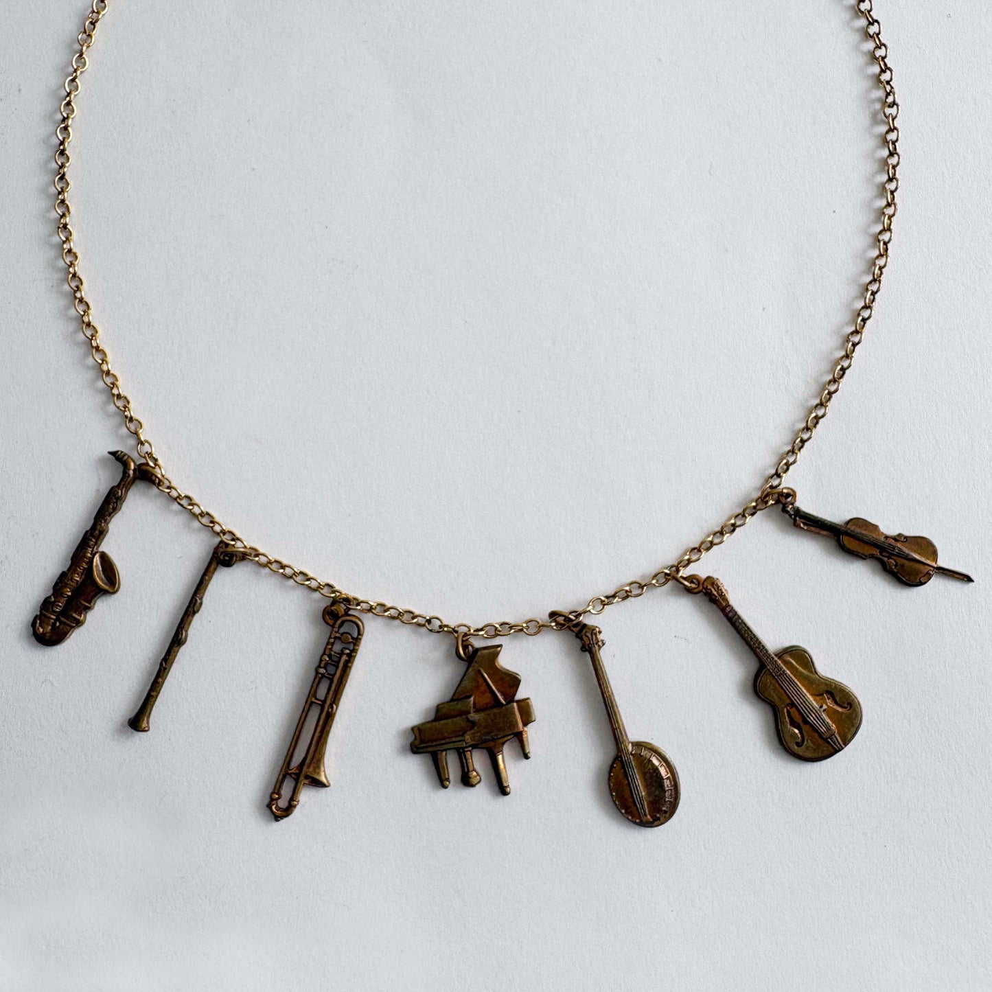 Vintage Pididdly Links brass musical instrument charm necklace with assorted instrument charms